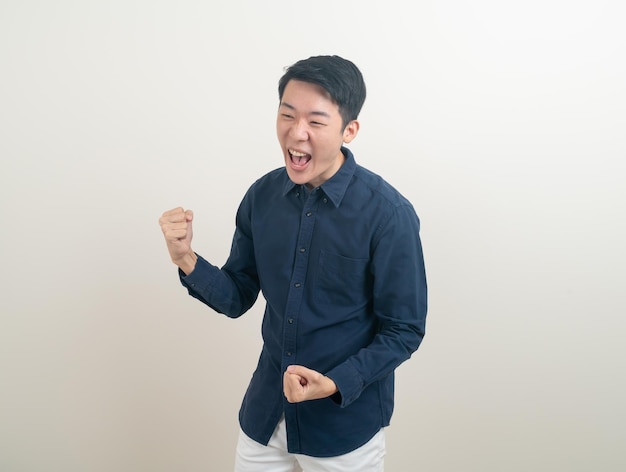 young Asian man with successful action on white background