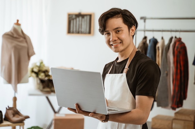 Young asian man working in a clothes shop