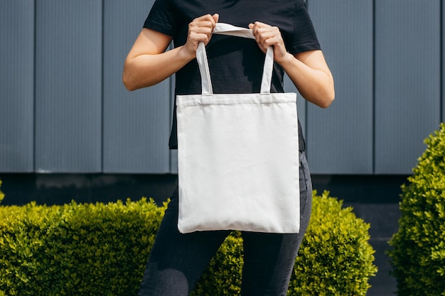 Photo young asian model girl on the street holding white eco bag mock up