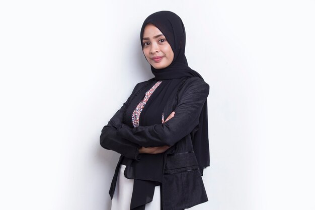 Young asian muslim business woman in head scarf smile with arms crossed on white background