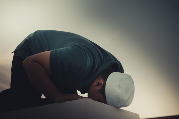 A Young asian muslim man praying on sunsetRamadan festival concept