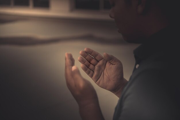 A Young asian muslim man praying on sunsetRamadan festival concept