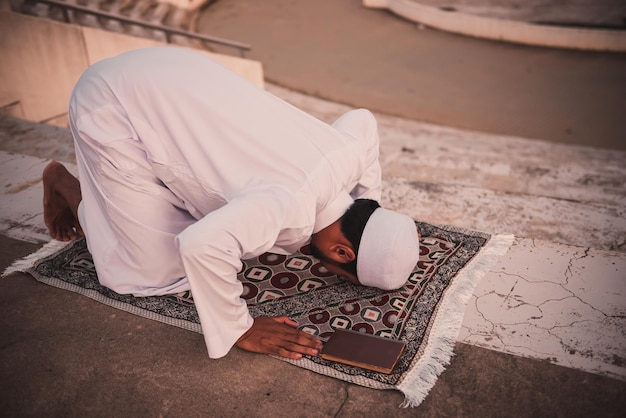 A Young asian muslim man praying on sunsetRamadan festival concept