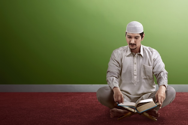 Young asian muslim people reading koran