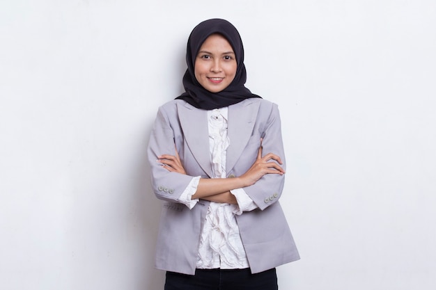 Young asian muslim woman in head scarf smile with arms crossed on white background