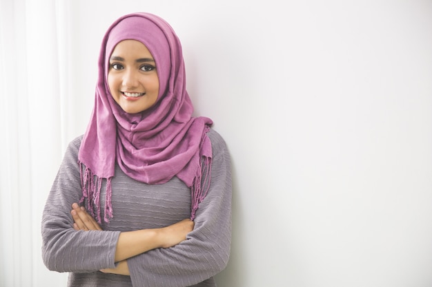 Young asian muslim woman in head scarf smiles