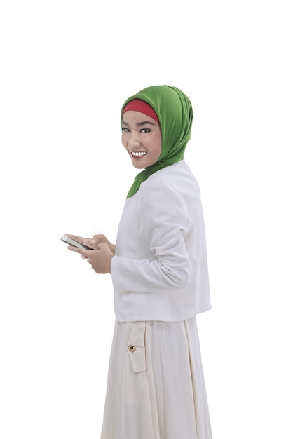 Young asian muslim woman hold the phone on hand