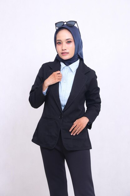 young asian office woman in blue shirt hijab standing to the camera elegantly hands on jacket and po