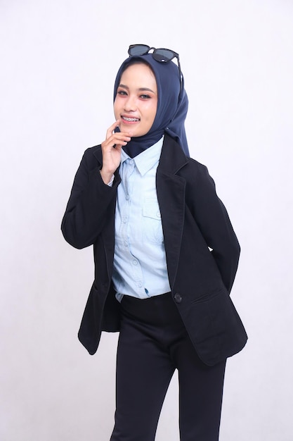 young asian office woman in blue shirt hijab standing slouching to the camera cheerful smile hands