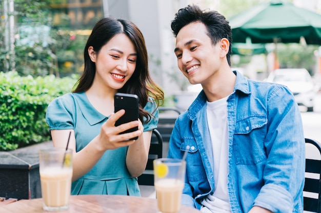 Young Asian people working together at coffee shop