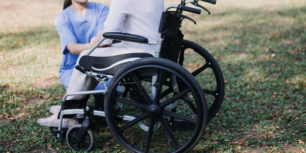 Young asian physical therapist working with senior woman on walking with a walker