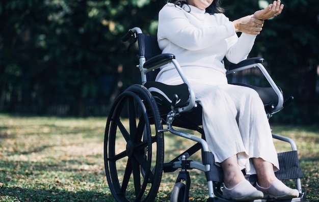 Young asian physical therapist working with senior woman on walking with a walker