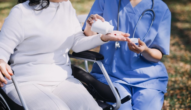 Young asian physical therapist working with senior woman on walking with a walker