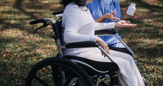 Young asian physical therapist working with senior woman on walking with a walker