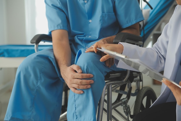 young asian physical therapist working with senior woman on walking with a walker