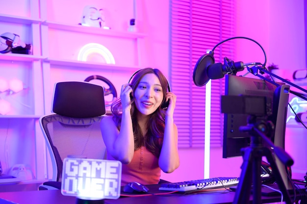 Young Asian Pretty woman Pro Gamer have live streaming singing and chatting with her fans at home