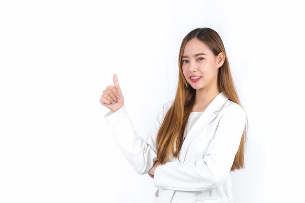 Young Asian professional female with bronze long hair wearing white suit pretty and thumbs up