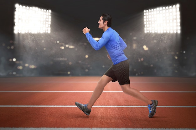 Young asian runner man running 