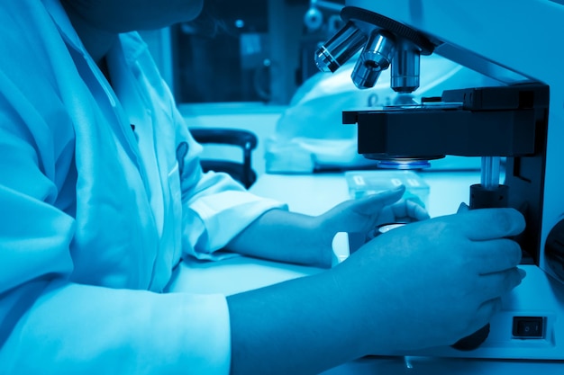 Young asian scientist looking through a microscope in a laboratoryThailand people doing some research