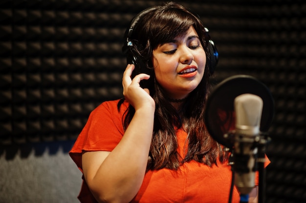 Young Asian singer recording in the studio