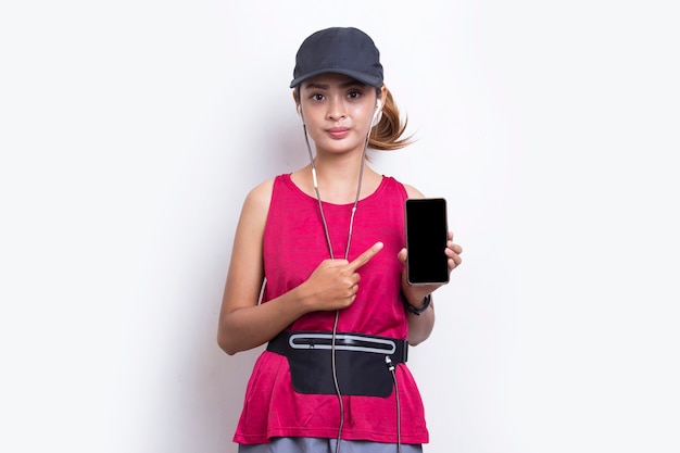 young asian sporty woman demonstrating mobile phone on white background