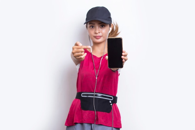 young asian sporty woman demonstrating mobile phone on white background