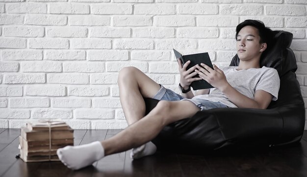 Young Asian student sitting on pillow and getting ready for exam