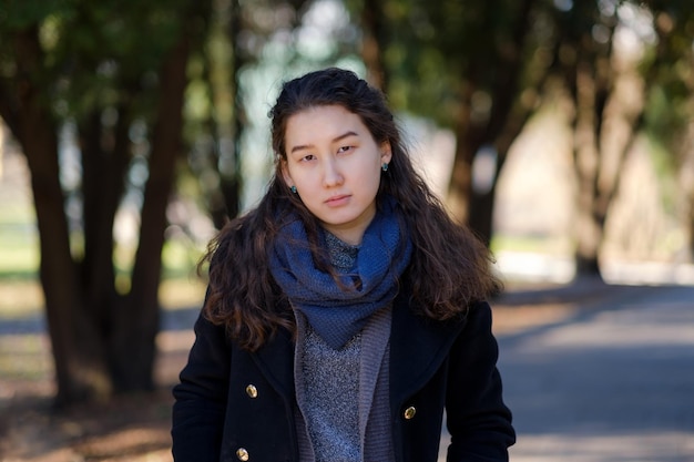 Young asian student on sunny day in park