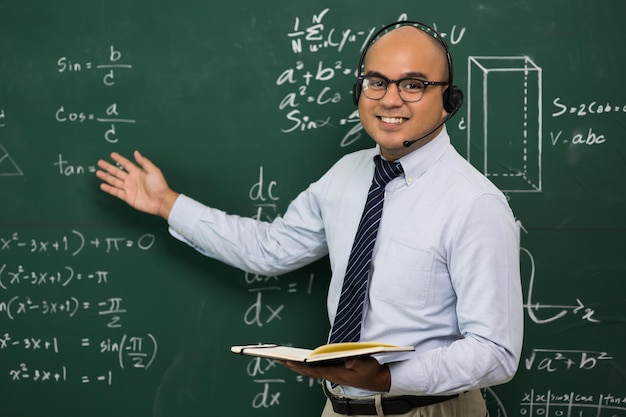 Young asian teacher man teaching video conference with\
student