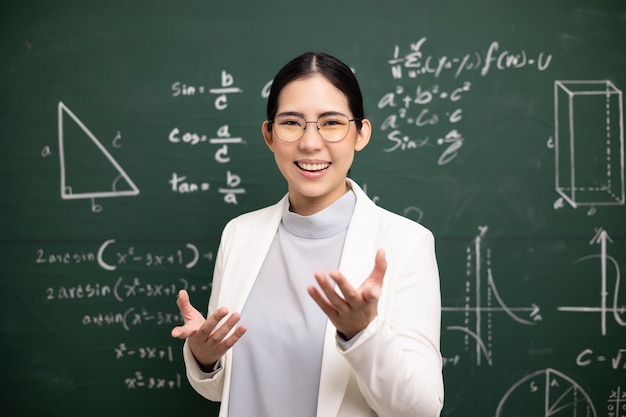 Young asian teacher woman teaching speak to camera video\
conference with student female teacher training the mathematics in\
classroom blackboard from online course