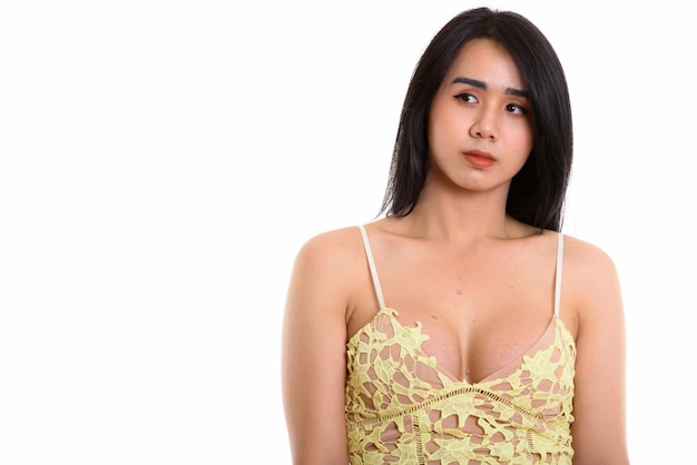 young Asian transgender woman thinking while looks at the distance