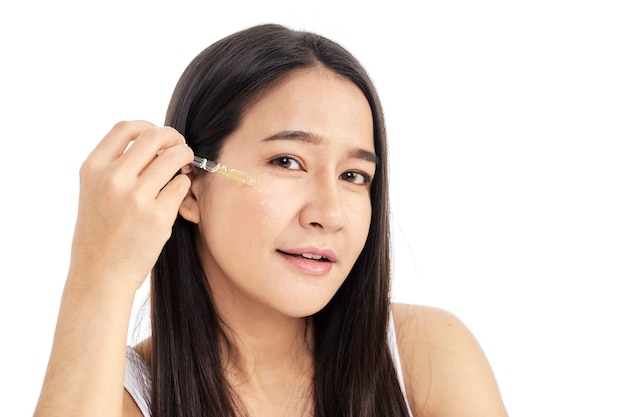 Young Asian woman applying oil serum from the pipette. Natural organic cosmetic products for facial skincare .skincare concept