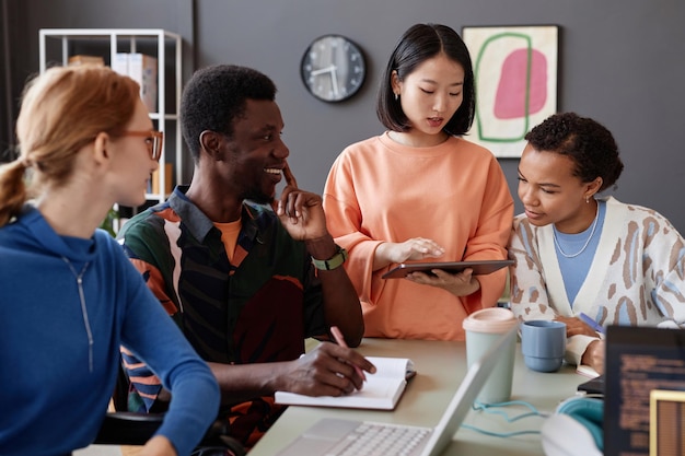 Young asian woman as manager instructing diverse team