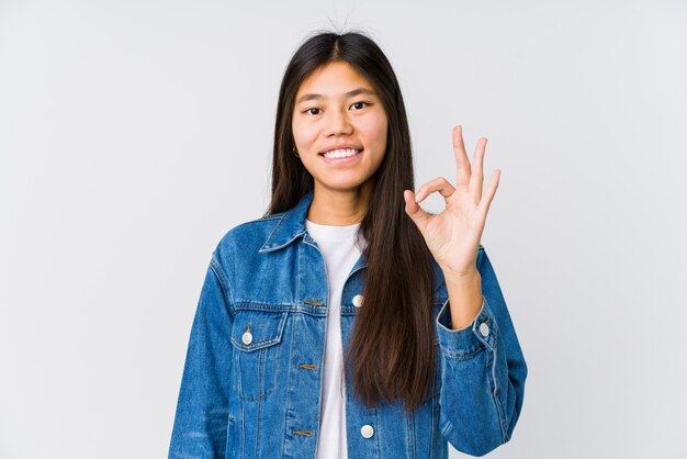 Young asian woman cheerful and confident showing ok gesture.