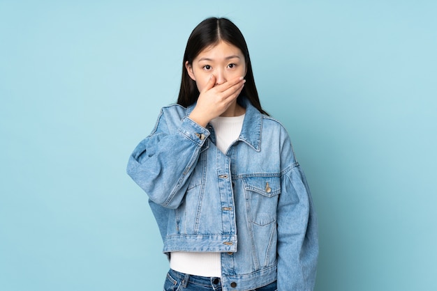 Young asian woman covering mouth with hand