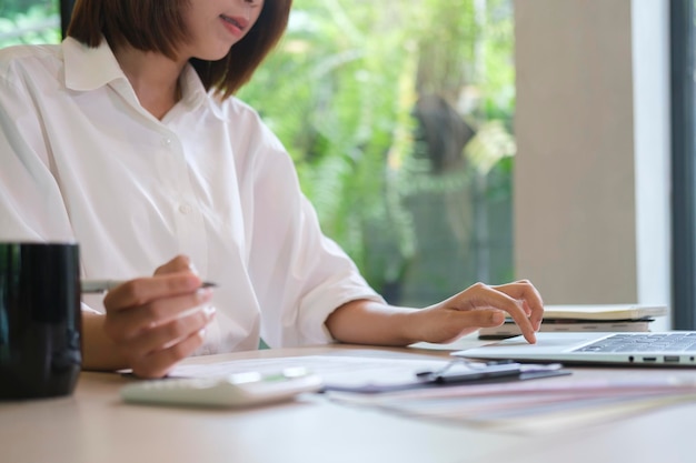 Young asian woman designer working with computer laptop in creative office