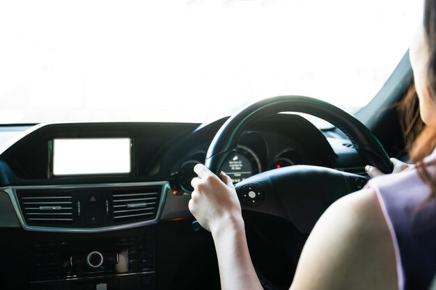 Young asian woman driving a car while the rain carefully, woman\
pay an attention on the road during driving a car in the rain.\
safety and responsibility transportation concept