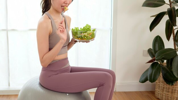 Photo young asian woman in enjoying eating healthy food after work out