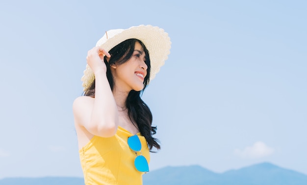 Young Asian woman enjoying summer vacation on the beach