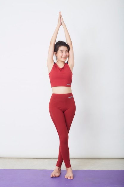 Young Asian woman exercise over light background