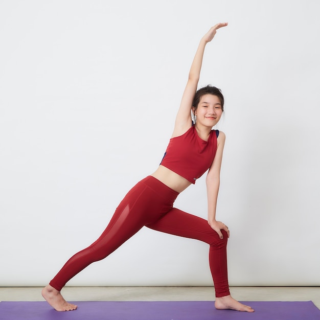 Young asian woman exercise over light background