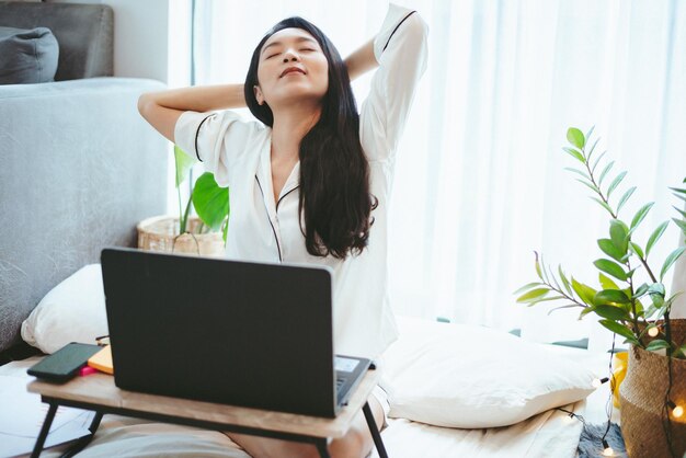 Young Asian woman freelance working business work on laptop at home, working from home concept