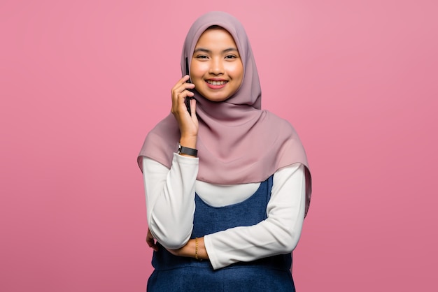Young asian woman happy and talking on mobile phone