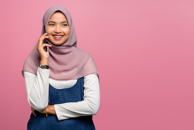 Young asian woman happy and talking on mobile phone