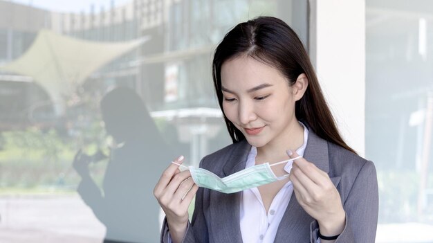 young asian woman has a mask ready to wear prevention of pathogens or epidemics of the corona virus