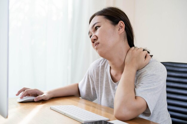 Young asian woman having an office syndrome health problem
after overworking for a long time. asian working woman suffer
injury at her neck. discomfort work place make people
uncomfortable.