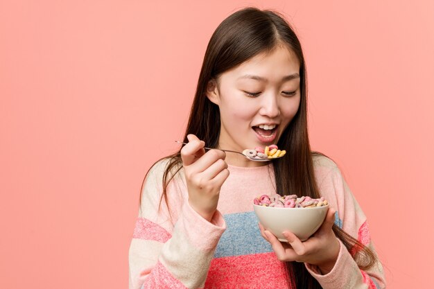 Young asian woman holding a cereal bowl