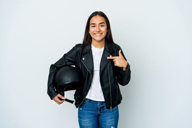 Young asian woman holding a motorbike helmet person pointing by hand to a shirt copy space, proud and confident