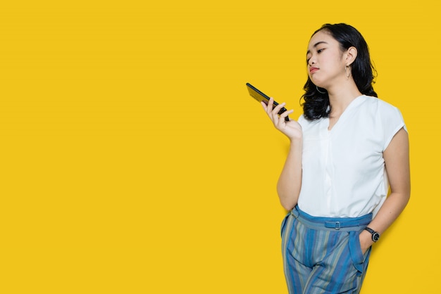 Young asian woman holding smartphone