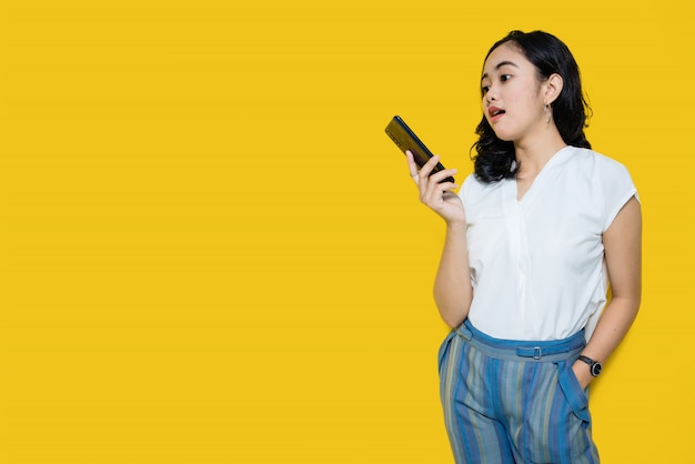 Young Asian woman holding smartphone